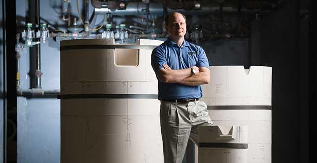 Phil Geers, Blasch Senior Market Manager for Molten Metals, standing in front of an InterLok Crucible system.